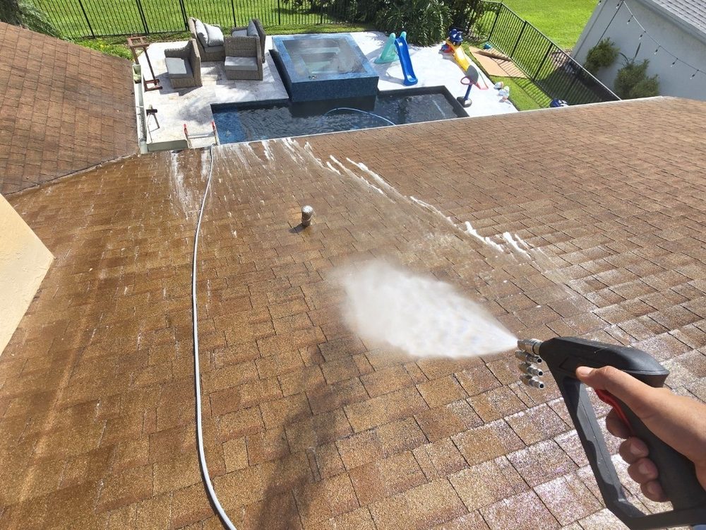 Soft washing a shingle roof at low pressure